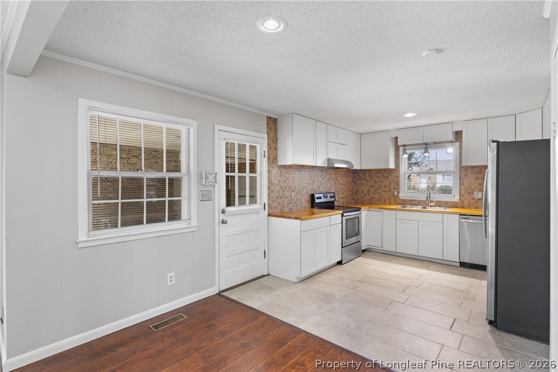 400 Hallmark Road Fayetteville, NC 28303 - Photo 15 of 37 a kitchen with refrigerator and window