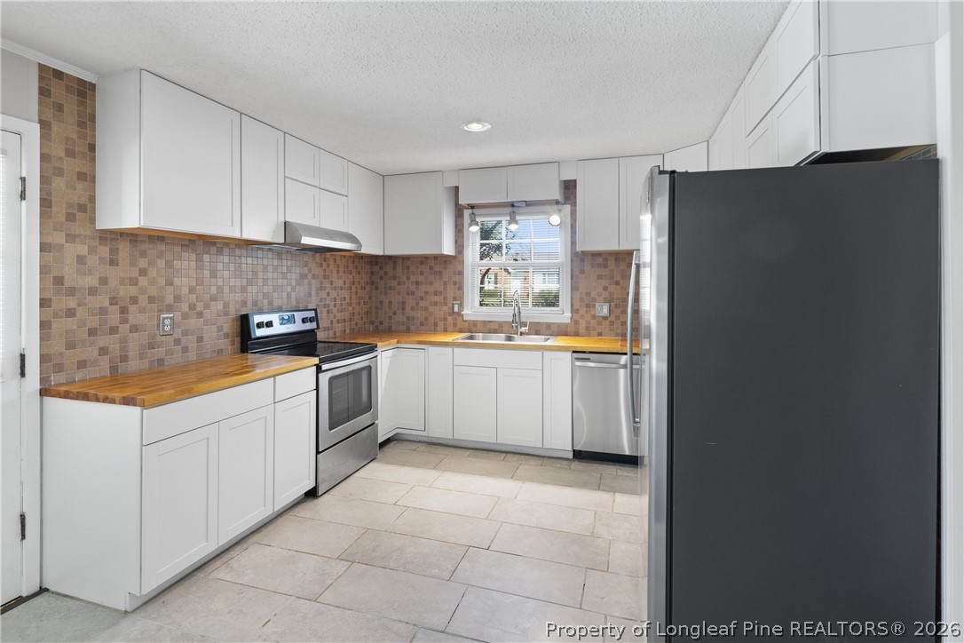 400 Hallmark Road Fayetteville, NC 28303 - Photo 16 of 37 a kitchen with a sink a counter top space stainless steel appliances and cabinets