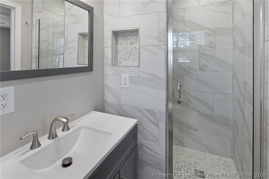 400 Hallmark Road Fayetteville, NC 28303 - Photo 25 of 37 a bathroom with a sink and a mirror