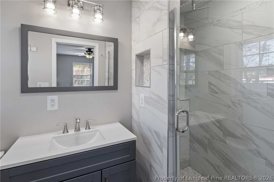 400 Hallmark Road Fayetteville, NC 28303 - Photo 26 of 37 a bathroom with a sink a mirror and shower