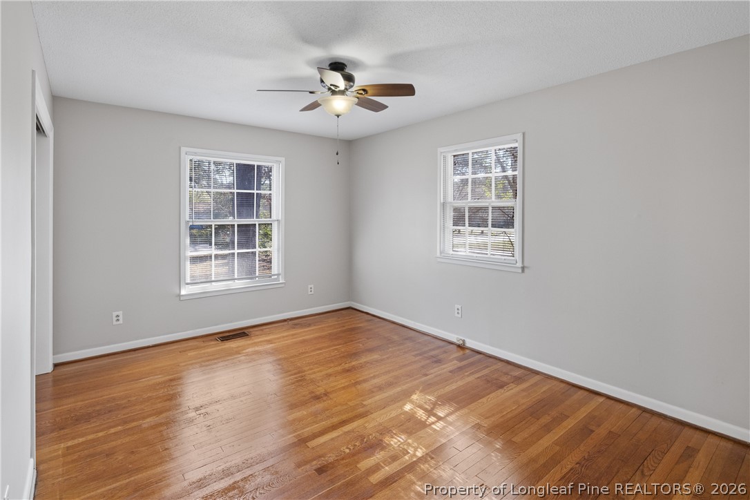 400 Hallmark Road Fayetteville, NC 28303 - Photo 32 of 37 a view of an empty room with a window and wooden floor