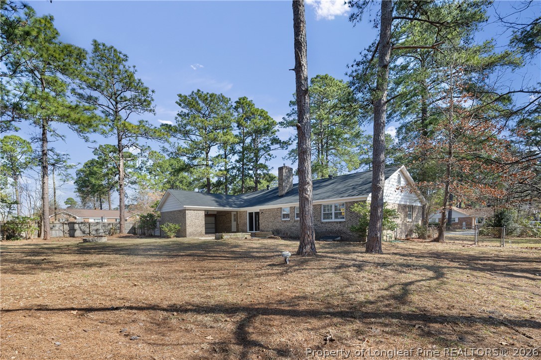 400 Hallmark Road Fayetteville, NC 28303 - Photo 36 of 37 a backyard of a house with large trees and plants