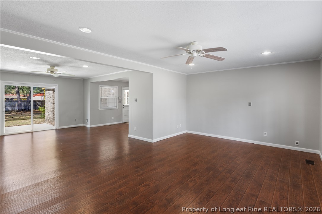 400 Hallmark Road Fayetteville, NC 28303 - Photo 7 of 37 an empty room with wooden floor and ceiling fan