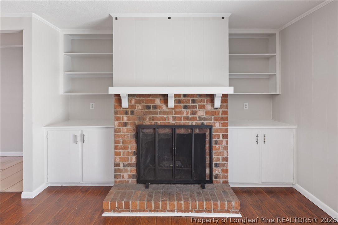 400 Hallmark Road Fayetteville, NC 28303 - Photo 9 of 37 a view of an empty room with wooden floor and a fireplace