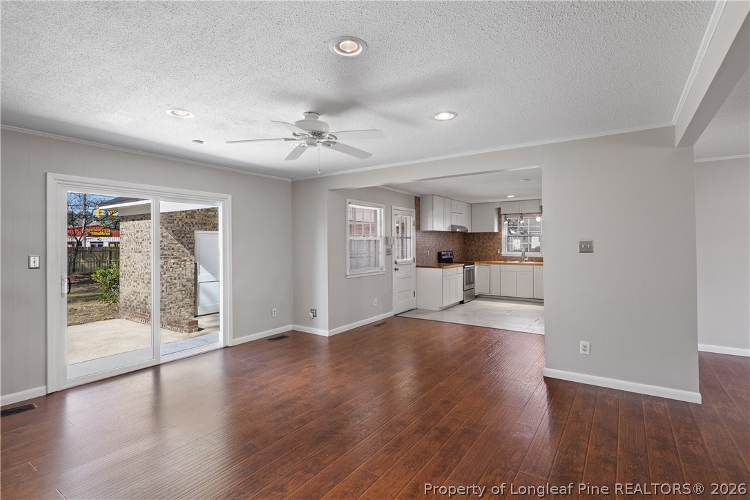 400 Hallmark Road Fayetteville, NC 28303 - Photo 10 of 37 a view of a big room with wooden floor a kitchen view and windows