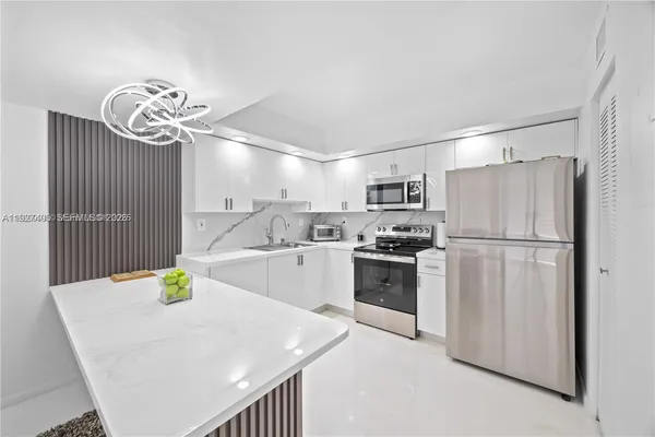 a kitchen with refrigerator cabinets and wooden floor
