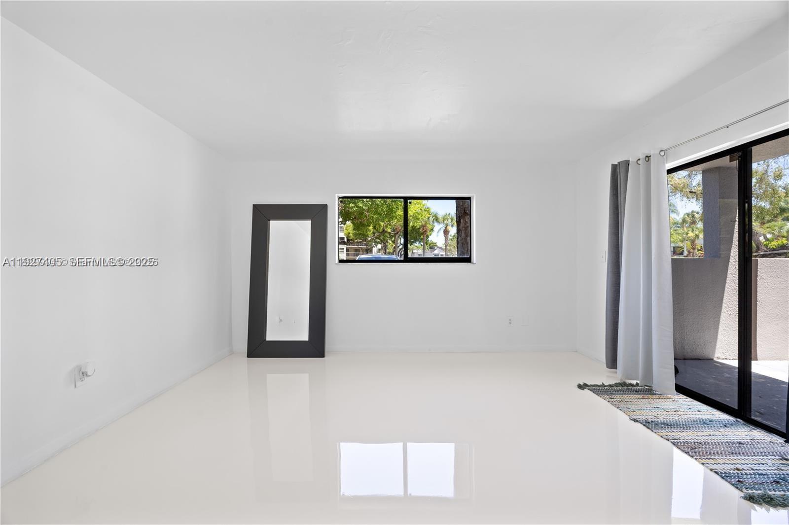 8810 Southwest 132nd Place, Unit 101DN Miami, FL 33186 - Photo 6 of 6 an empty room with windows