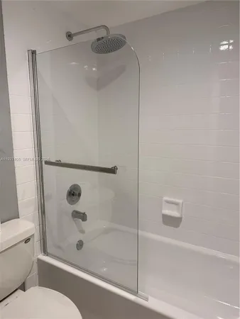a bathroom with a shower and a toilet