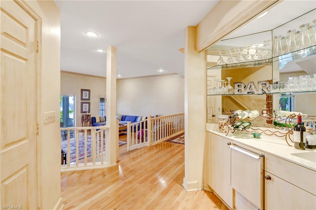 74 Seagate Drive, Unit 4 Naples, FL 34103 - Photo 14 of 35 a view of a bathroom with a sink and mirror