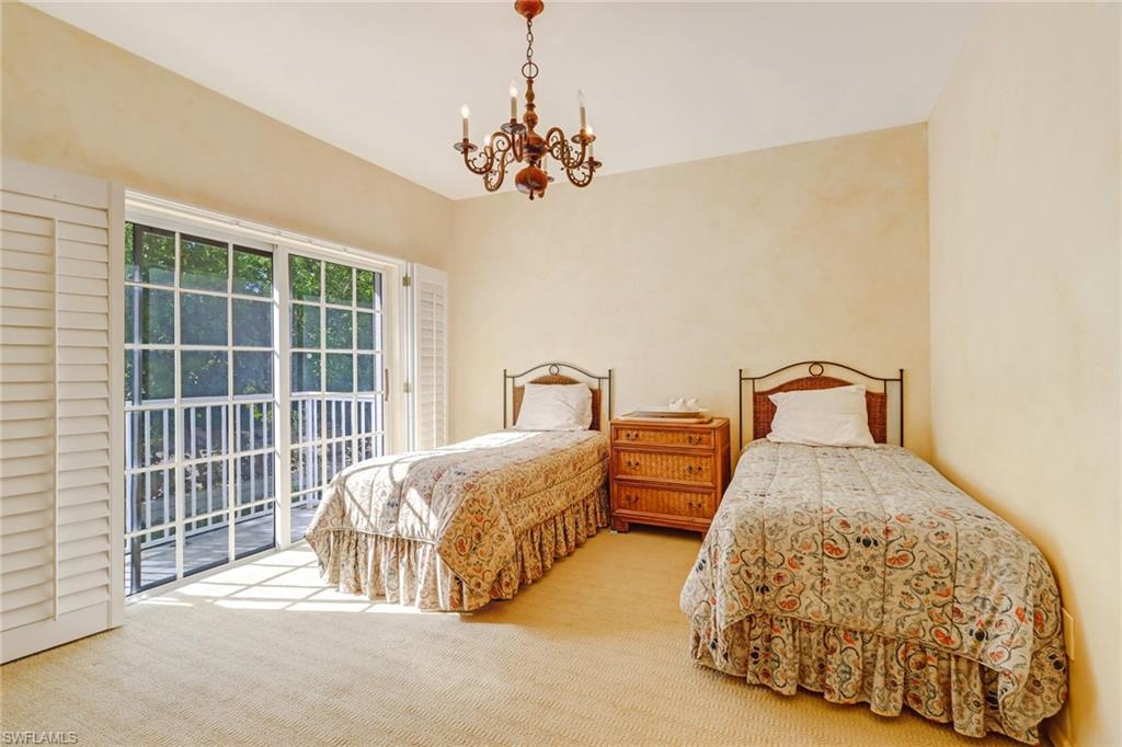 74 Seagate Drive, Unit 4 Naples, FL 34103 - Photo 15 of 35 a bedroom with bed and a window