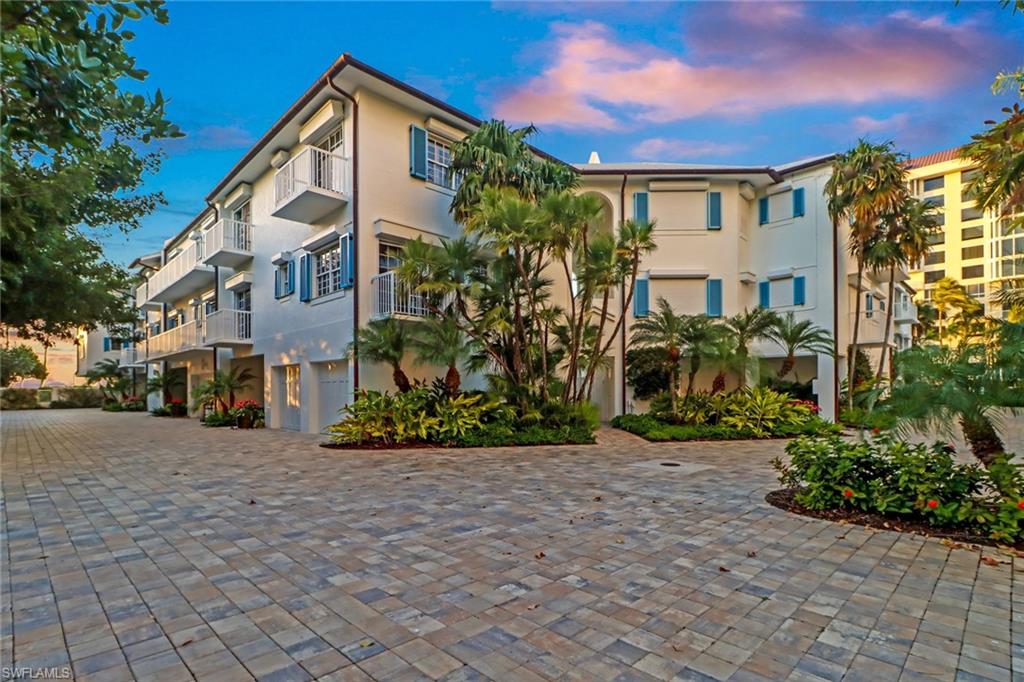 74 Seagate Drive, Unit 4 Naples, FL 34103 - Photo 2 of 35 a view of a house with a yard