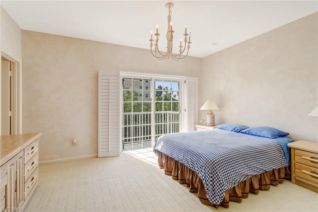 74 Seagate Drive, Unit 4 Naples, FL 34103 - Photo 21 of 35 a bedroom with a bed and a window in it