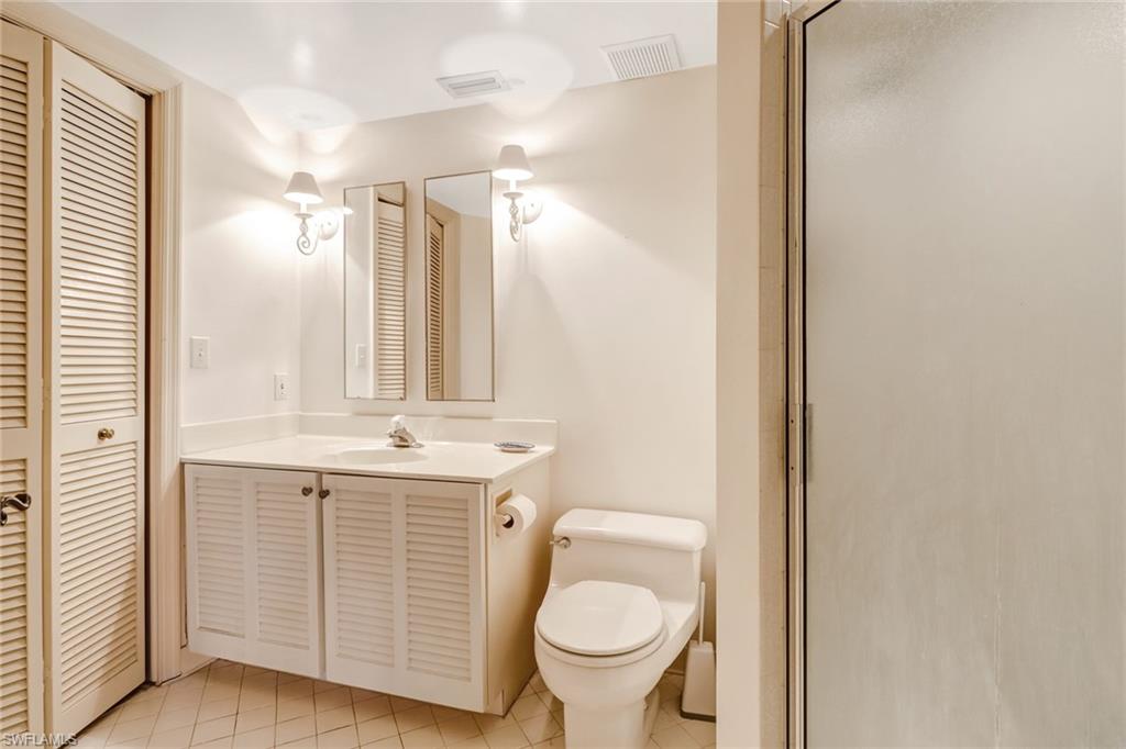 74 Seagate Drive, Unit 4 Naples, FL 34103 - Photo 29 of 35 a bathroom with a sink toilet and shower