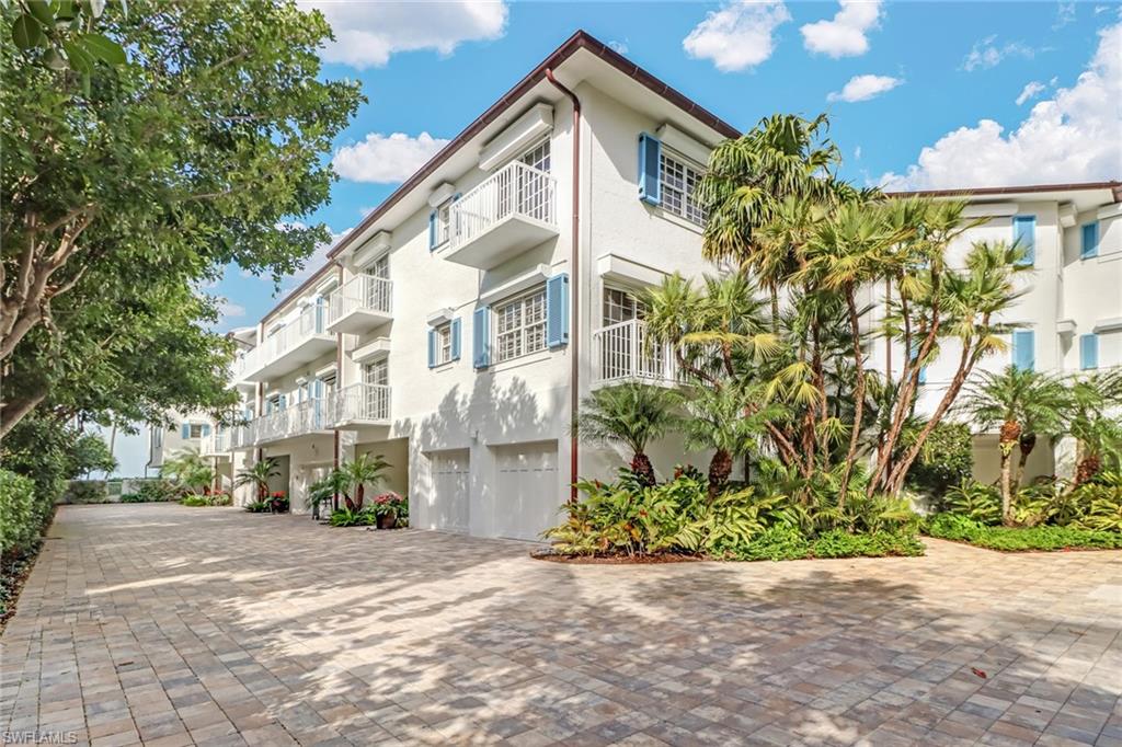 74 Seagate Drive, Unit 4 Naples, FL 34103 - Photo 30 of 35 a view of an house with backyard and tree