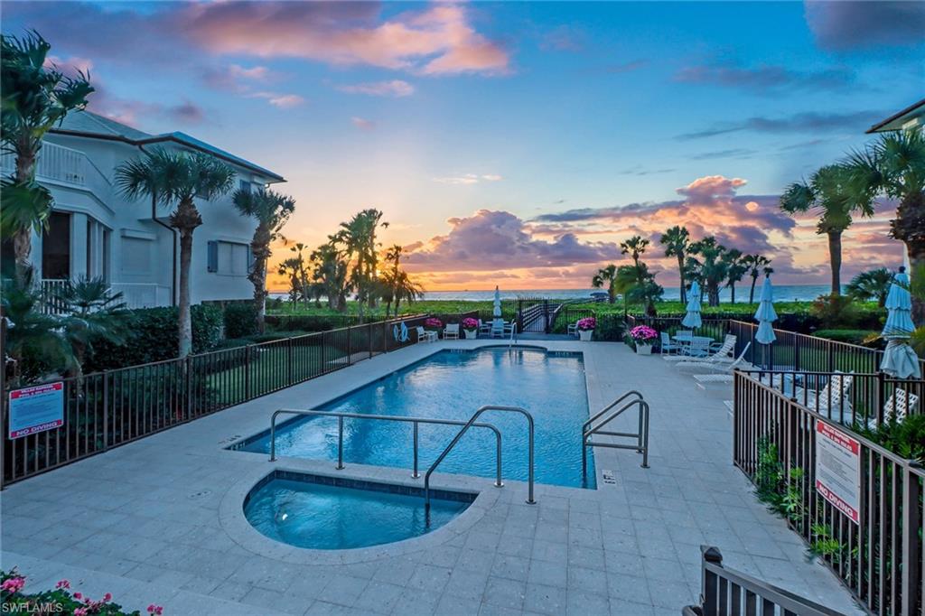 74 Seagate Drive, Unit 4 Naples, FL 34103 - Photo 3 of 35 a view of a swimming pool with a patio
