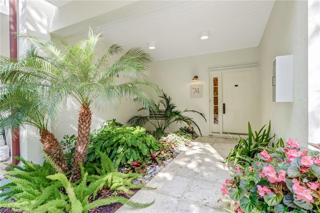 74 Seagate Drive, Unit 4 Naples, FL 34103 - Photo 31 of 35 a view of a flower in a garden