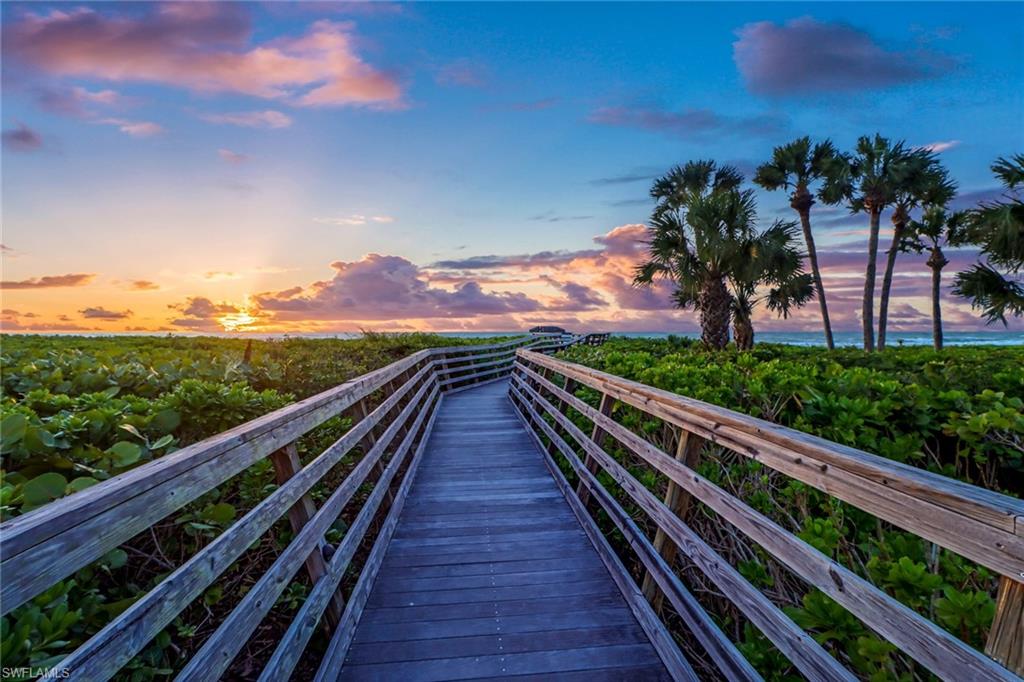74 Seagate Drive, Unit 4 Naples, FL 34103 - Photo 4 of 35 a view of balcony with wooden floor and fence