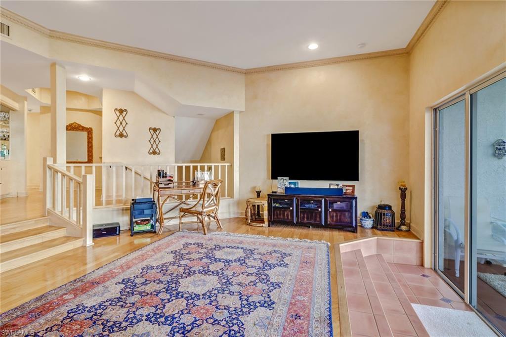 74 Seagate Drive, Unit 4 Naples, FL 34103 - Photo 9 of 35 a living room with furniture and a flat screen tv