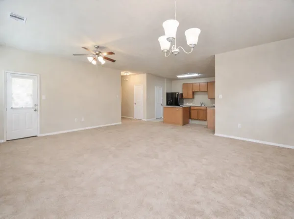 a view of a kitchen with a sink and a chandelier fan