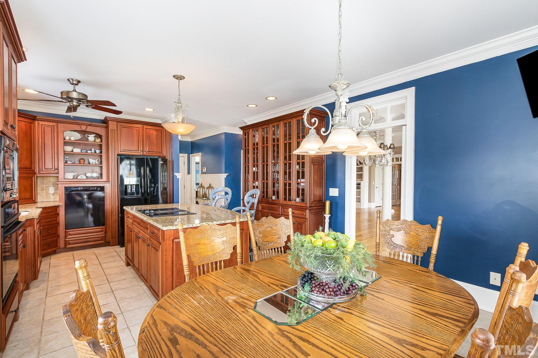 3733 Johnson Pond Road Raleigh, NC 27603 - Photo 15 of 41 a view of a dining room with furniture wooden floor and chandelier