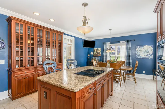 a kitchen with granite countertop a sink and a refrigerator