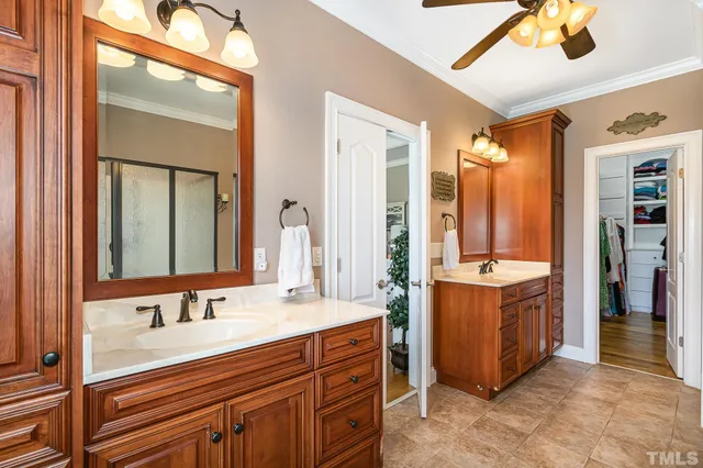 a bathroom with double vanity sink and a mirror