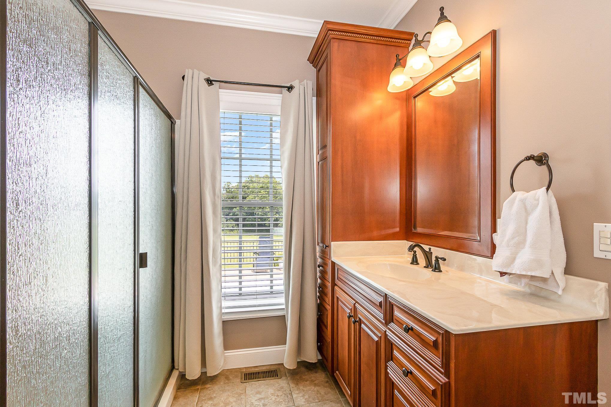 3733 Johnson Pond Road Raleigh, NC 27603 - Photo 21 of 41 a bathroom with a sink and a mirror