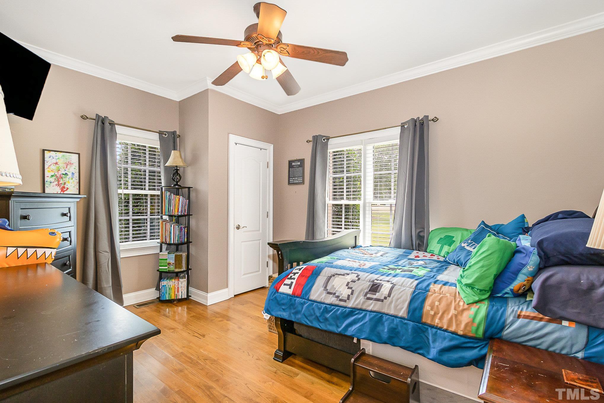 3733 Johnson Pond Road Raleigh, NC 27603 - Photo 23 of 41 a bedroom with a bed and a flat screen tv