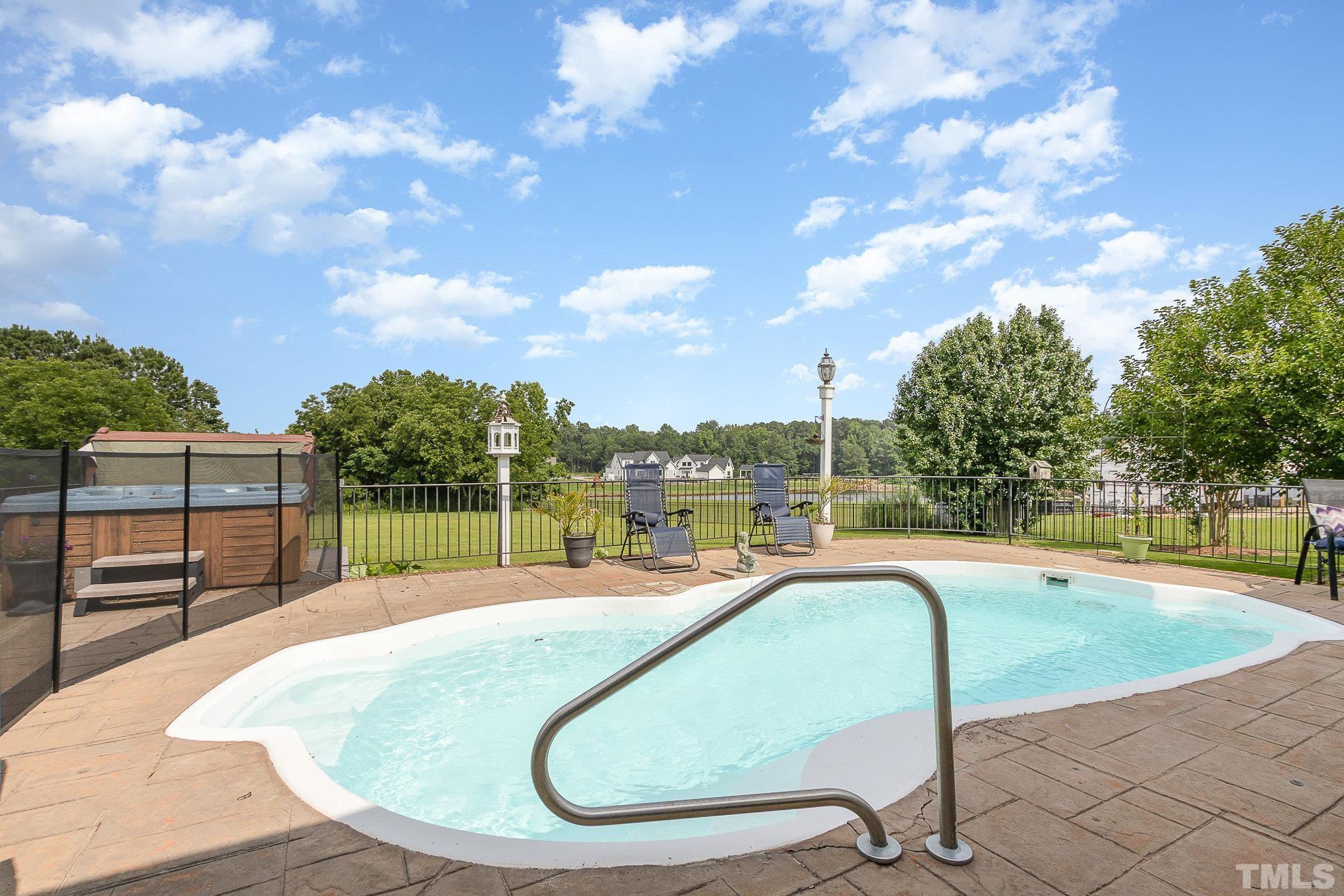 3733 Johnson Pond Road Raleigh, NC 27603 - Photo 29 of 41 a swimming pool with outdoor seating and city view