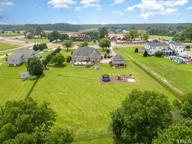 an aerial view of a houses with a lake view