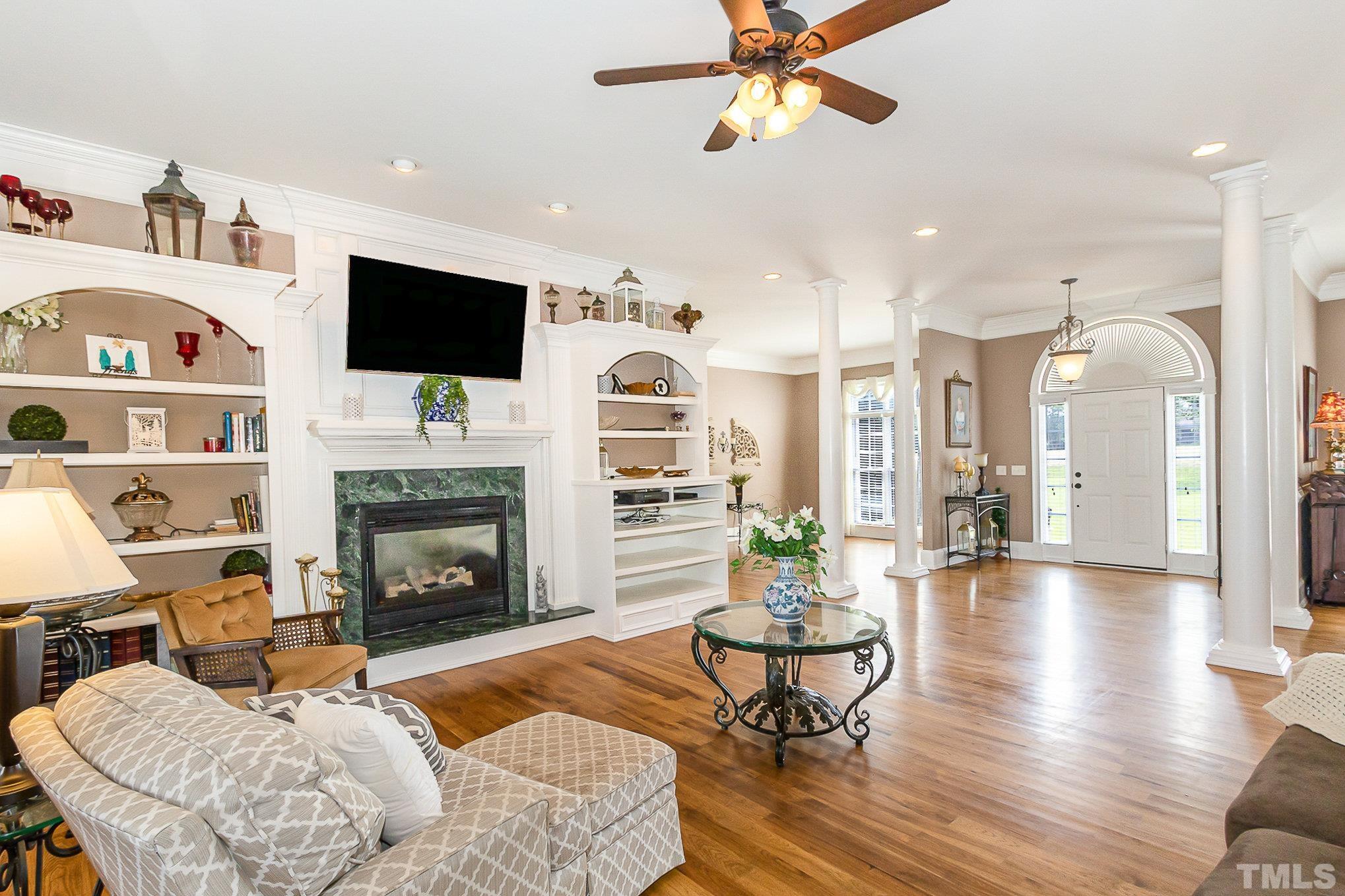3733 Johnson Pond Road Raleigh, NC 27603 - Photo 7 of 41 a living room with furniture fireplace and flat screen tv