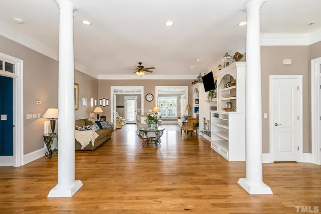 a living room with fireplace furniture and wooden floor