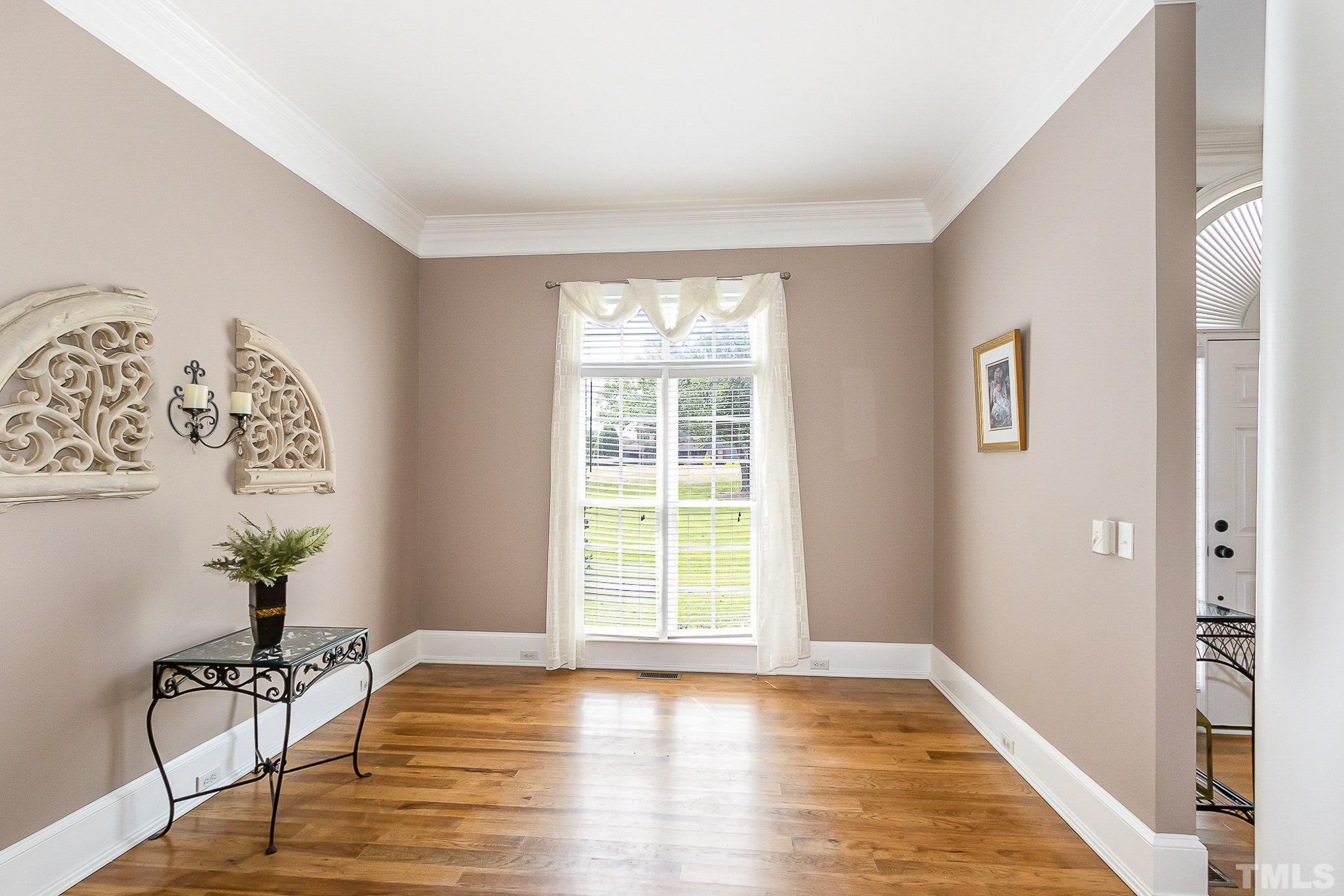 3733 Johnson Pond Road Raleigh, NC 27603 - Photo 10 of 41 a view of an empty room with wooden floor and a window