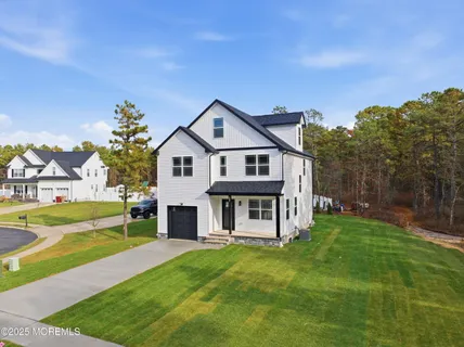 a view of a house with a yard porch and sitting area