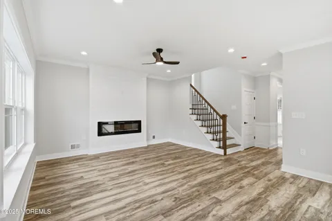 a view of a room with wooden floor and windows
