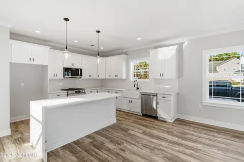 a view of room with wooden floor and ceiling fan