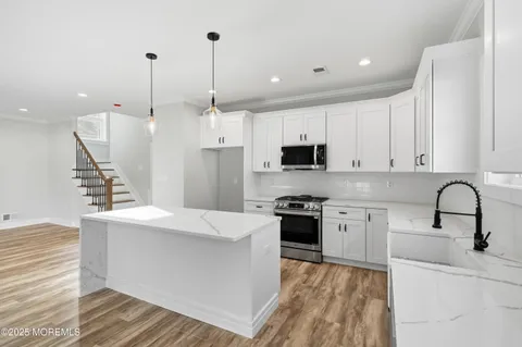 a bathroom with a shower sink and mirror