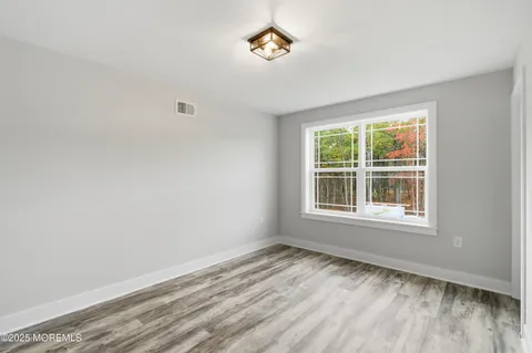 an aerial view of residential houses with outdoor space and trees
