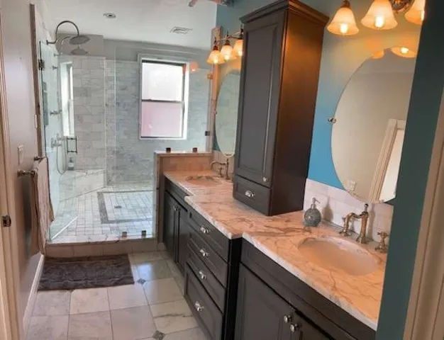 a bathroom with a glass shower door