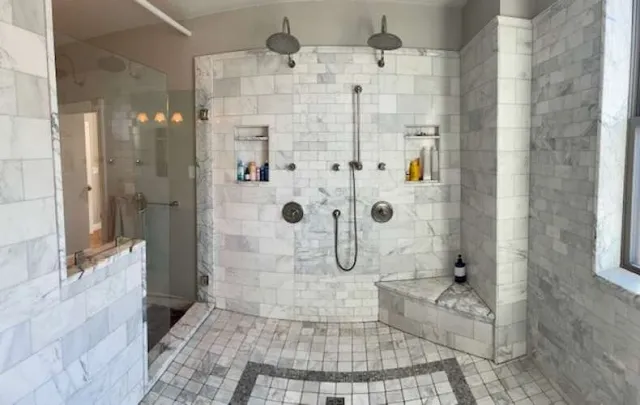a bathroom with a double vanity sink and a mirror