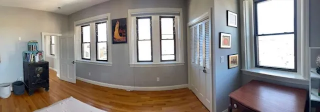 a room with a window and wooden floor