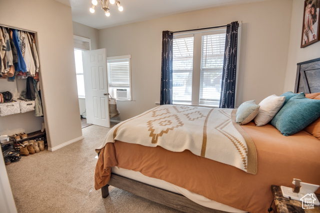 410 North Main Street Beaver, UT 84713 - Photo 12 of 31 Bedroom with light carpet, cooling unit, and an inviting chandelier