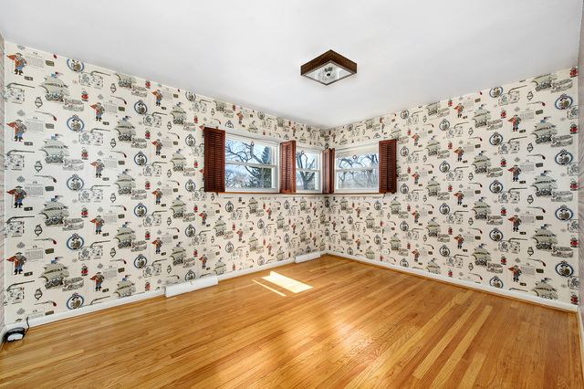 a bathroom with a toilet and a shower curtain