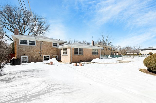 a view of a house with snow on the road