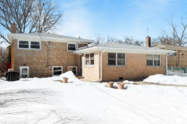 a view of a house with snow on the road