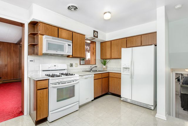 a kitchen with stainless steel appliances a refrigerator sink and microwave