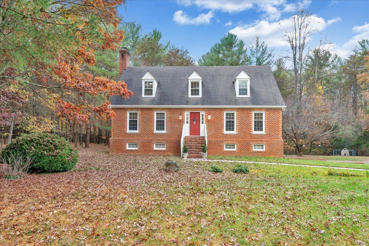 204 Raintree Lane Boones Mill, VA 24065 - Photo 1 of 58 a view of a brick house next to a yard with big trees