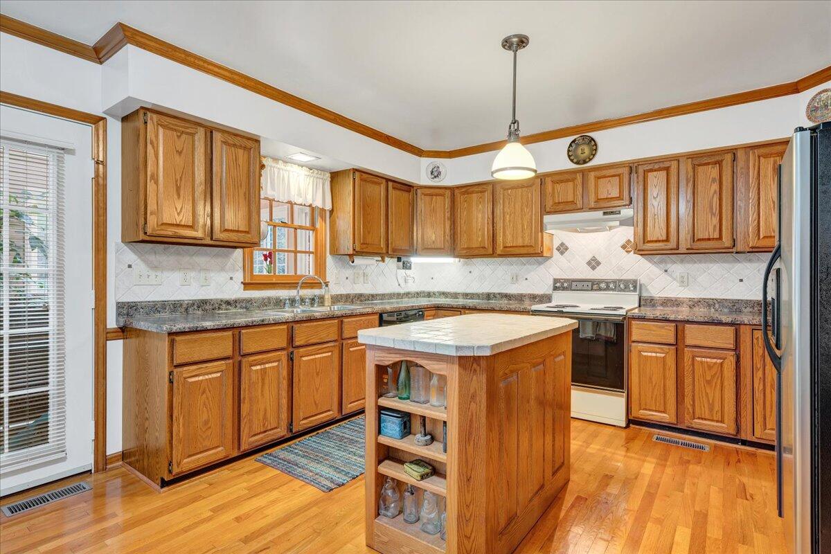 204 Raintree Lane Boones Mill, VA 24065 - Photo 11 of 58 a kitchen with stainless steel appliances granite countertop a sink stove and refrigerator