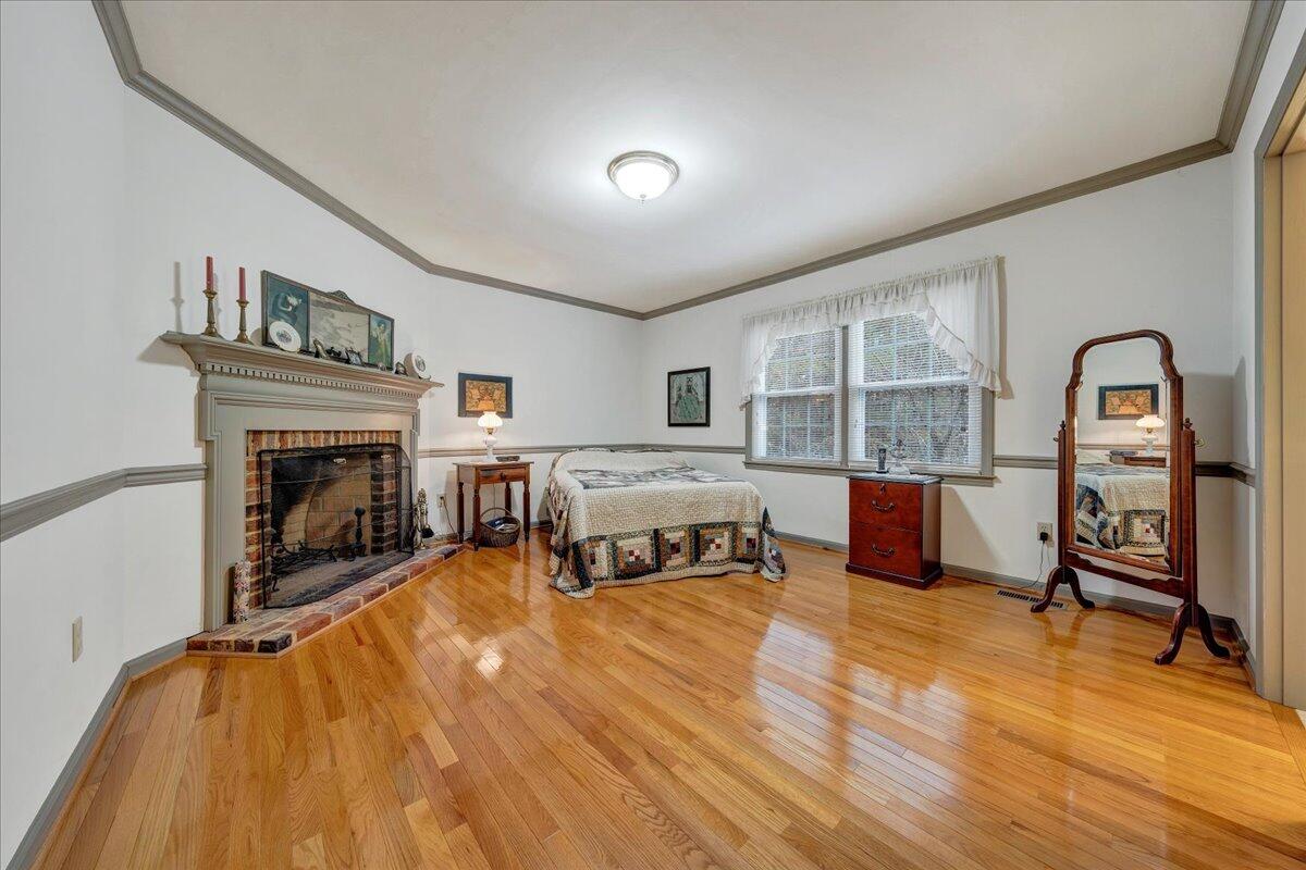 204 Raintree Lane Boones Mill, VA 24065 - Photo 16 of 58 a bedroom with furniture and a fireplace
