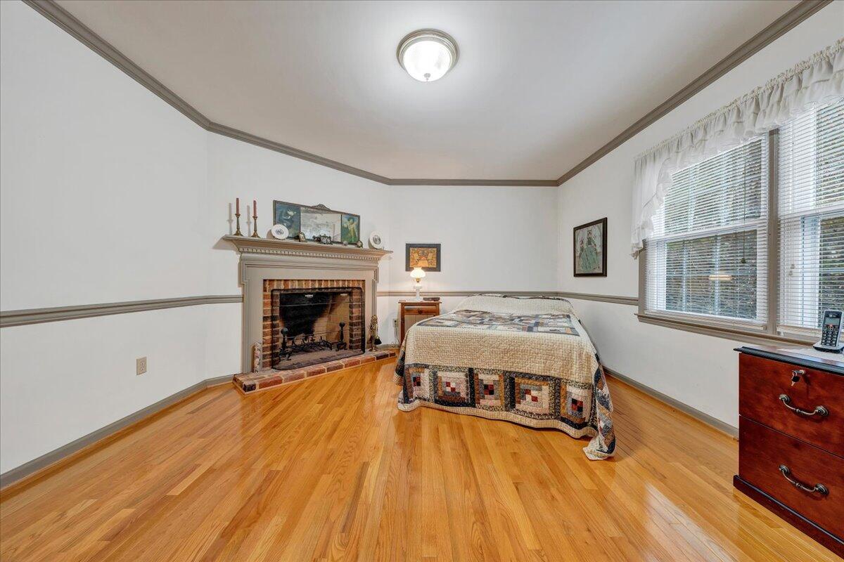 204 Raintree Lane Boones Mill, VA 24065 - Photo 17 of 58 a spacious bedroom with a bed and a fireplace